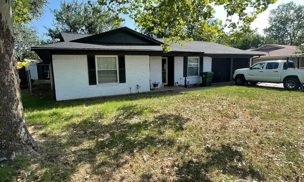 Professional roofing crew working on a residential roof in Manvel